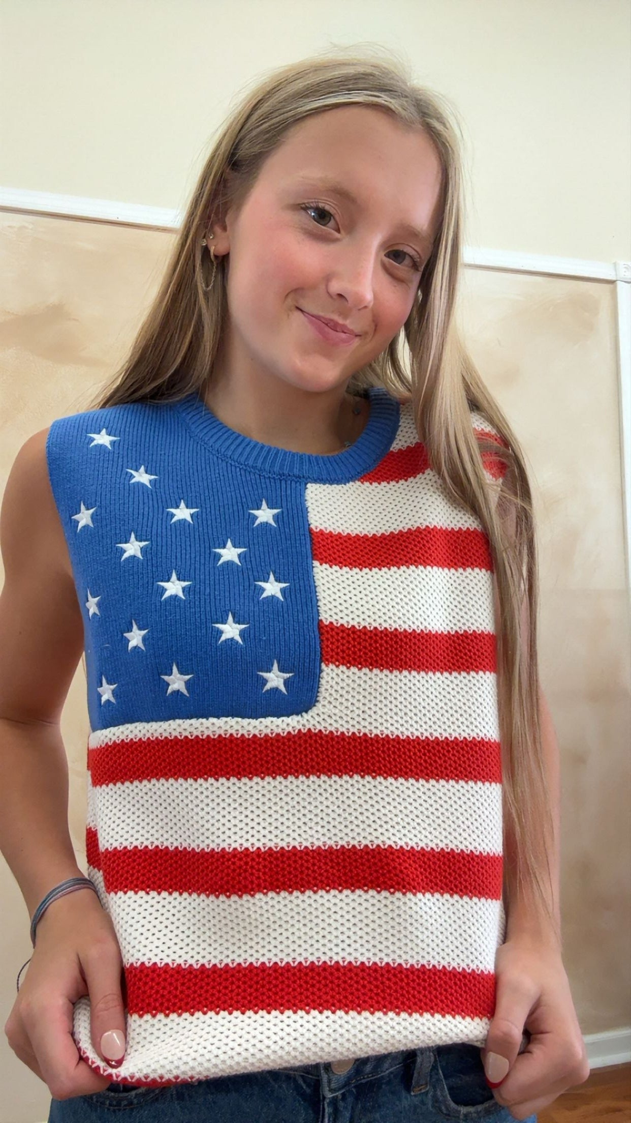 Person wearing a sweater with an American flag design